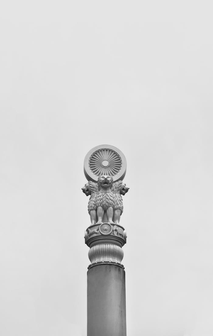 Black and white photo of the Ashoka Pillar capital featuring lions, symbolizing India's heritage.