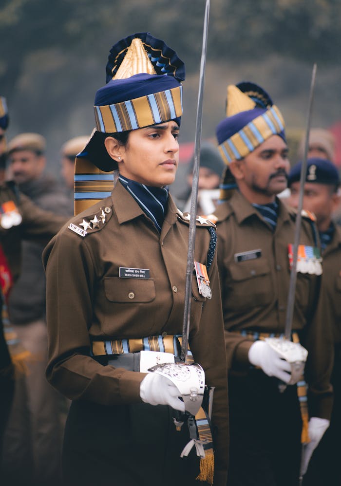 Indian military officers in uniform stand in formation, holding swords, showcasing discipline and honor.