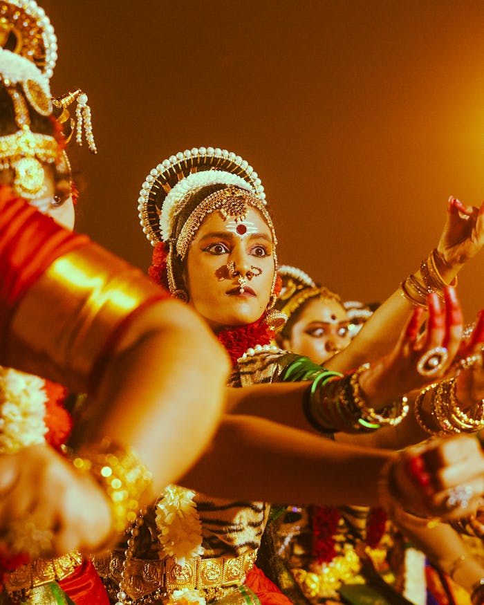 Traditional Indian dancers in ornate attire performing at Varanasi festival.