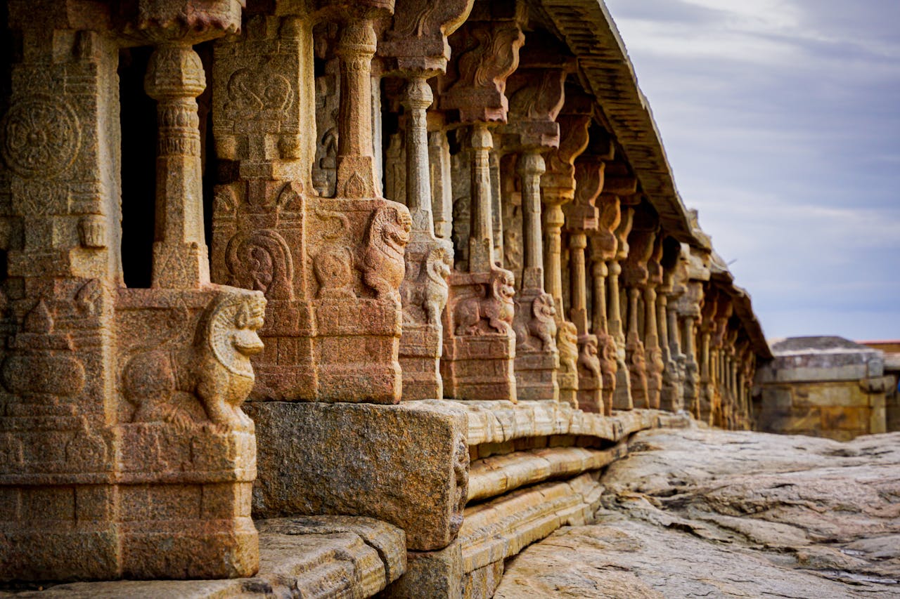 Close-up of detailed stone carvings on an ancient Indian temple exterior, reflecting rich cultural history.