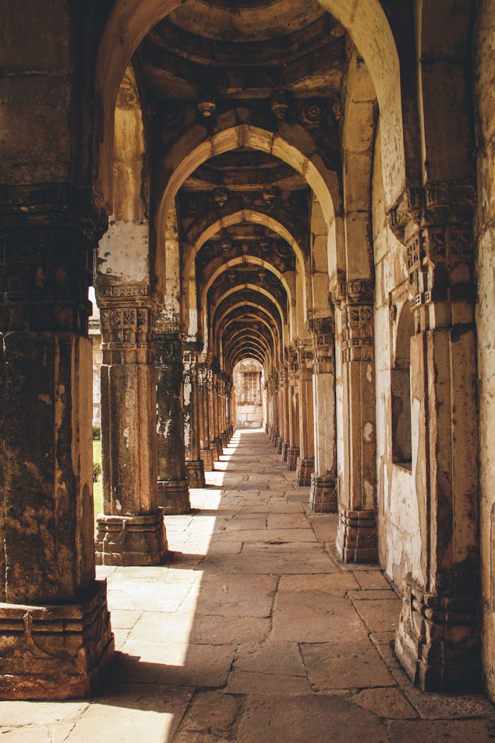 Explore the ancient arches of the Jama Mosque, a UNESCO World Heritage Site in Champaner, India.