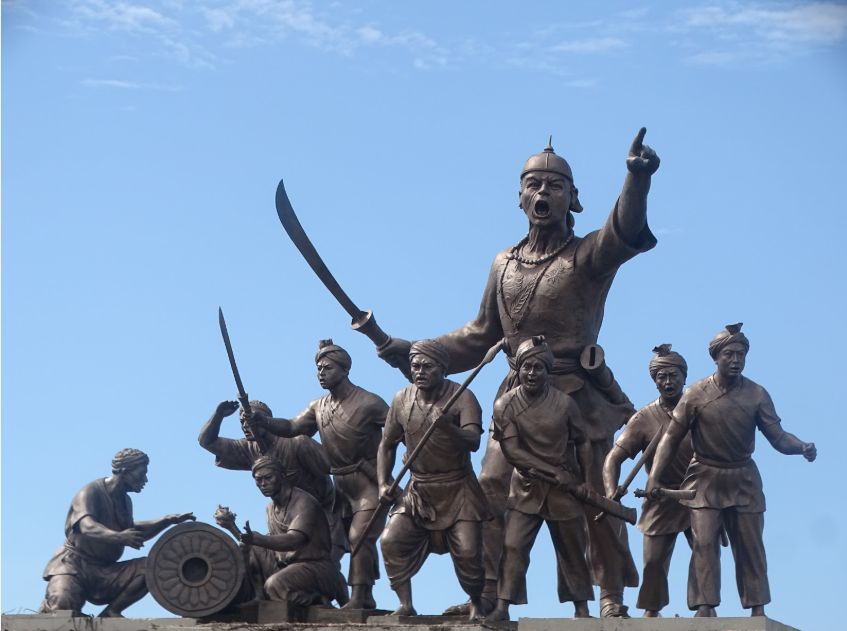 Lachit Borphukan: The General Who Saved the Northeast The monumental bronze statue of Lachit Borphukan and his Ahom soldiers, standing proud in the middle of the Brahmaputra River near Guwahati, Assam.